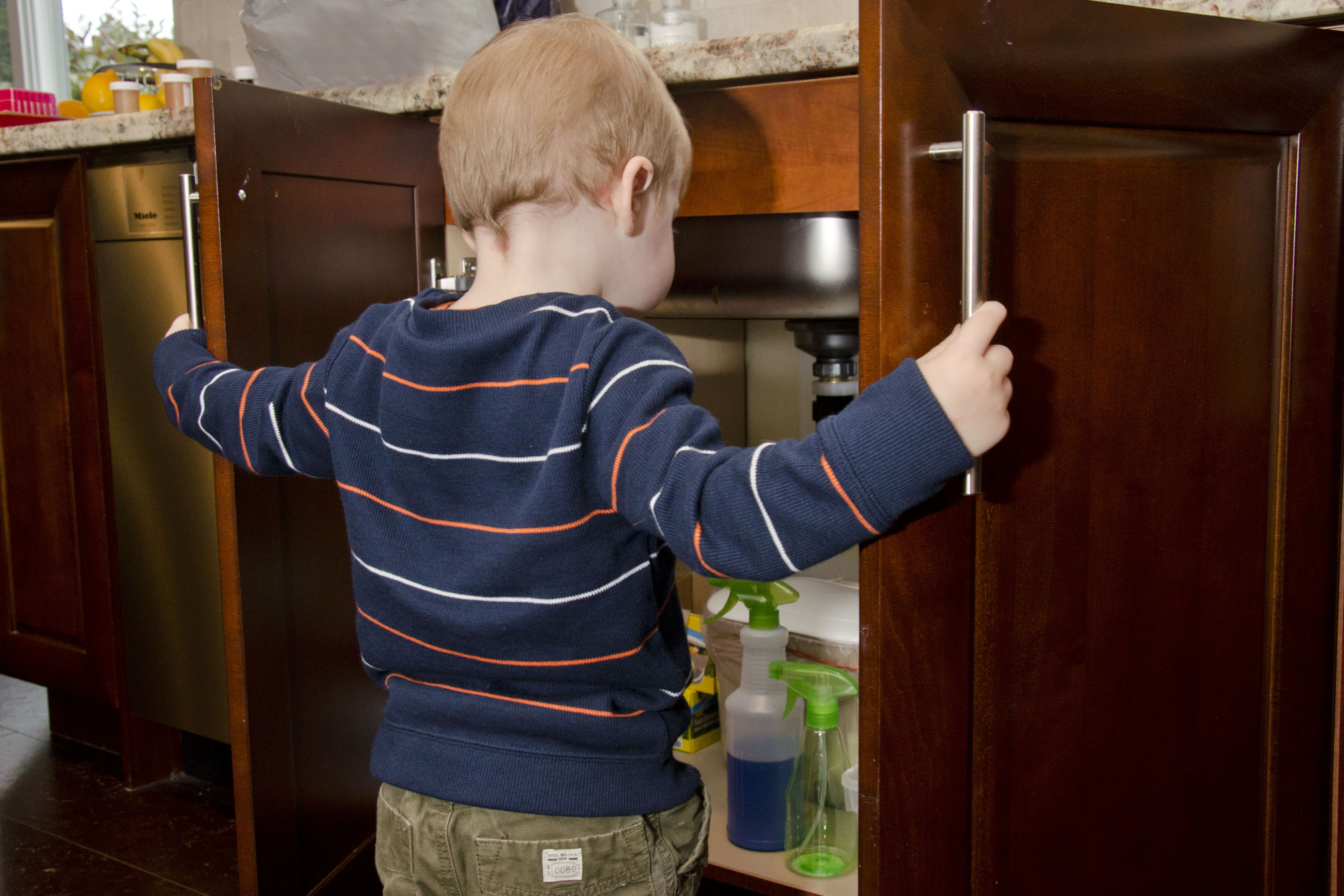 child accessing cabinet