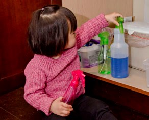 Child playing with cleaners